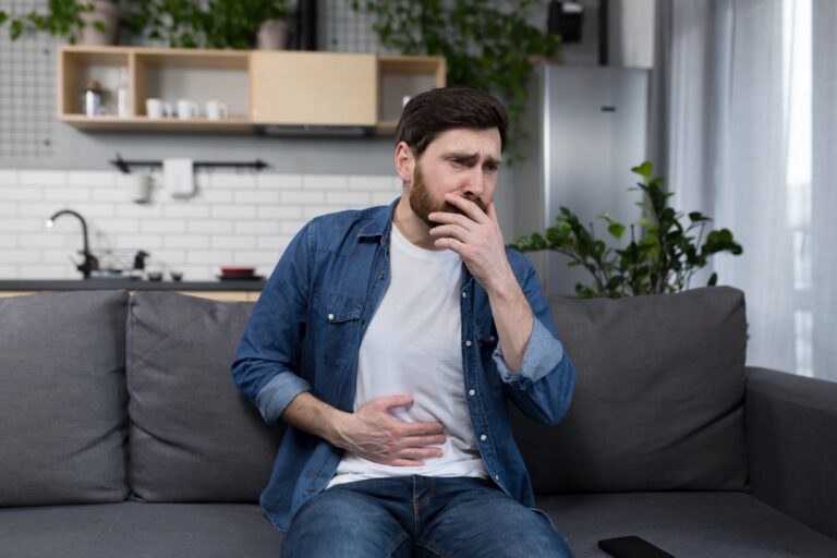 Man looking like he is nauseous because of his anxiety disorder