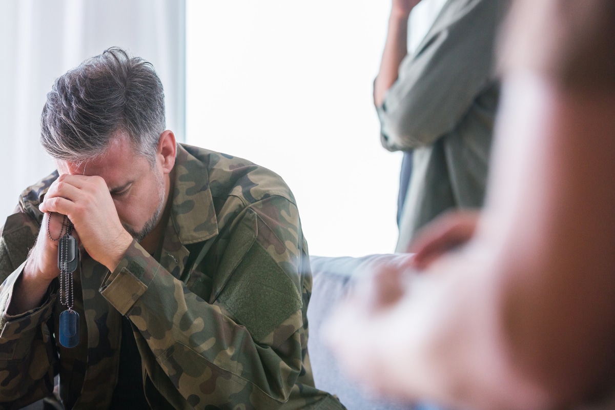 Man crying in therapy wondering if his PTSD will go away