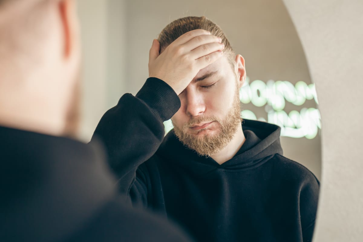Man looking into a mirror and wondering if BPD is curable