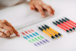 Person with OCD lining up pens and paper clips