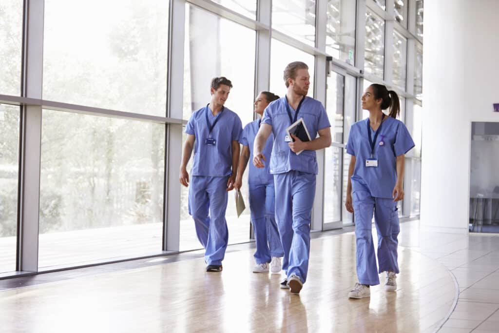 admissions | four healthcare workers in scrubs walking in corri 2021 08 26 16 13 53 utc